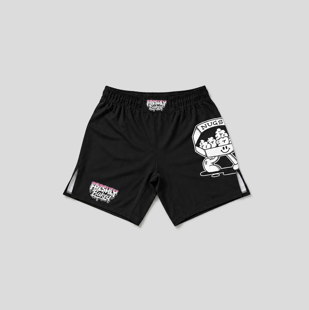 Black athletic shorts with white and pink graphics, featuring a large cartoon graphic on the right leg and a smaller graphic on the left leg, shown against a solid gray background.