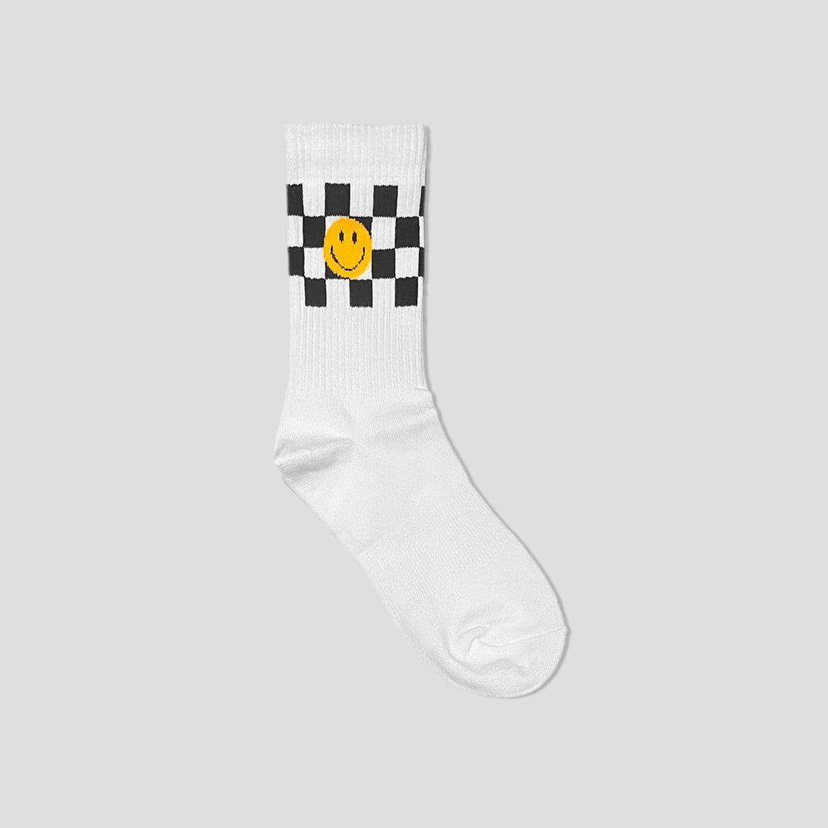 A single white crew sock with a black and white checkered pattern around the cuff, featuring a yellow smiley face in the center, shown against a solid light gray background.