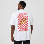 A man wearing a white oversized t-shirt, viewed from the back. The shirt features a large graphic print of a pepperoni pizza slice on a red and white checkered square, with the words 'LEGALISE' above and 'MARINARA' below in red.