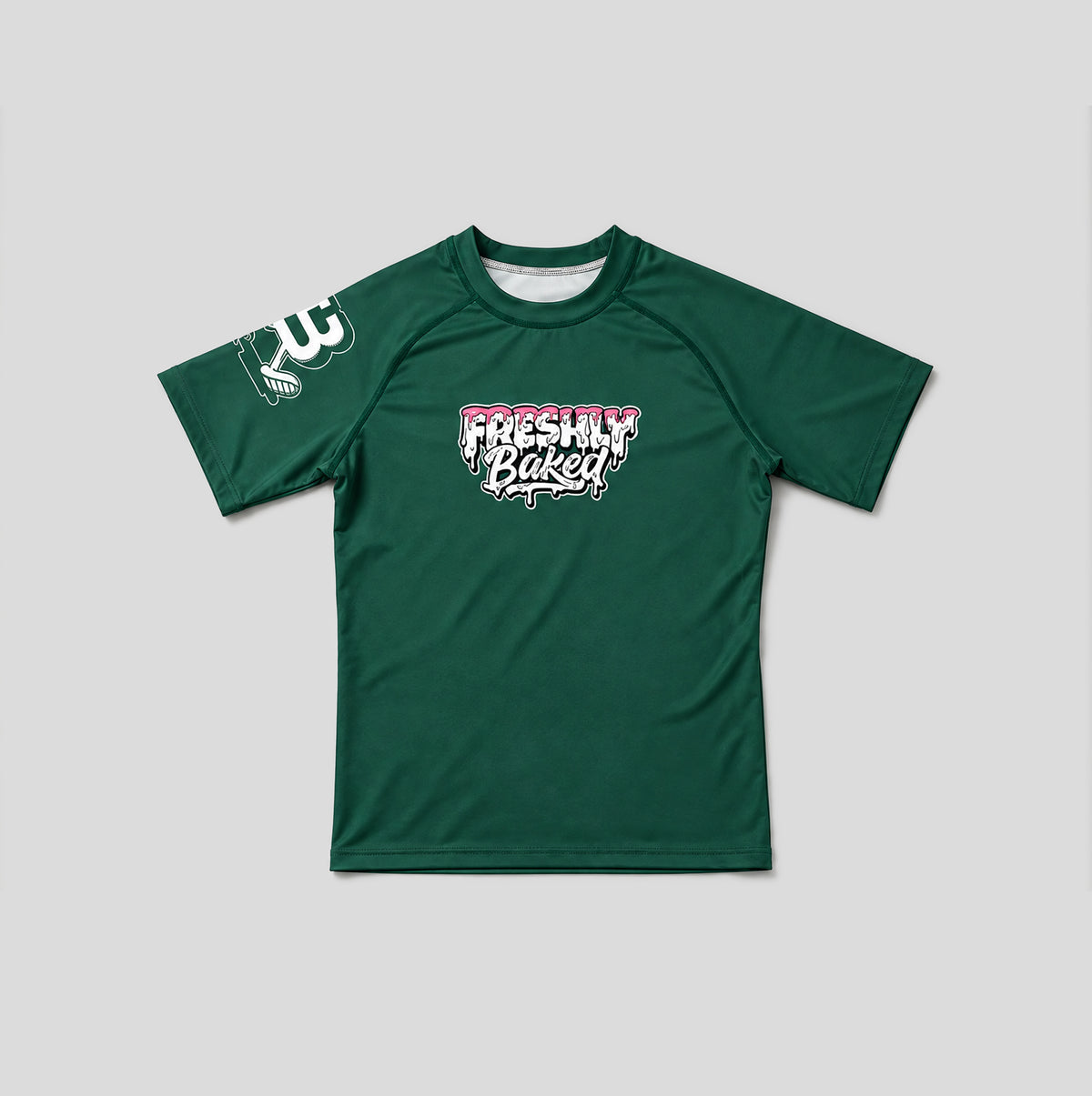 A dark green short-sleeve athletic t-shirt with a 'Freshly Baked' graphic on the chest and a white graphic on the right sleeve, displayed flat against a light gray background.