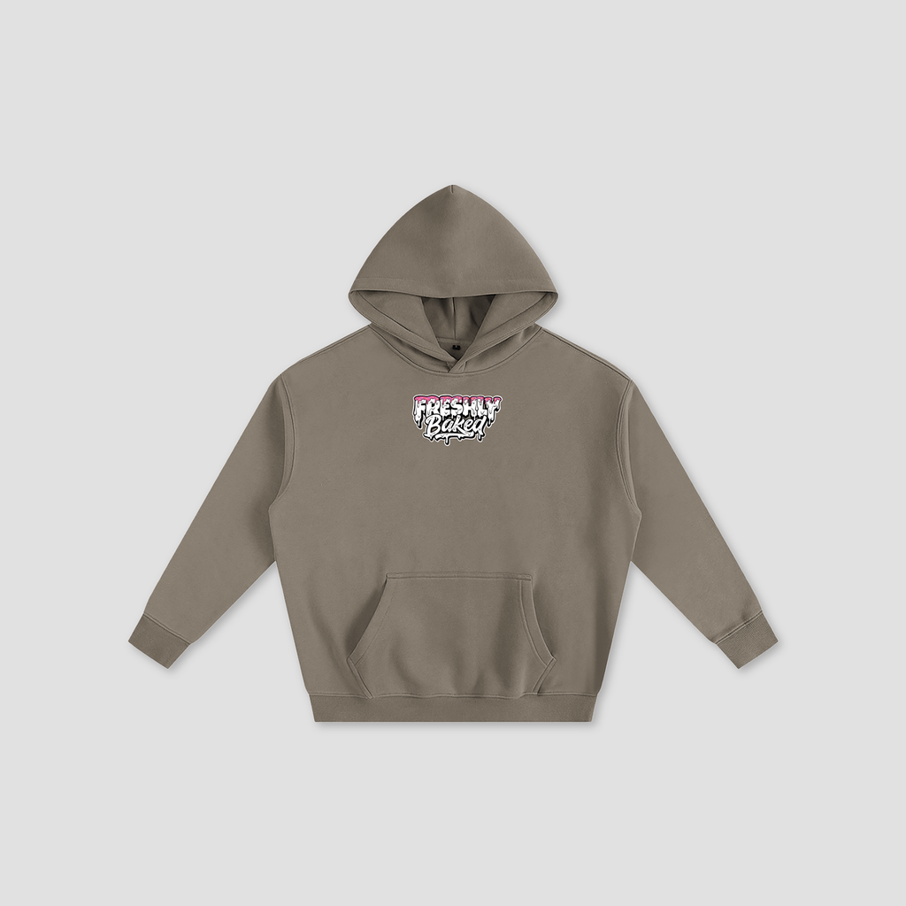 A taupe brown pullover hoodie with a front kangaroo pocket and a small graphic on the chest reading 'FRESHLY BAKED' in pink, white, and black, displayed on a light gray background.