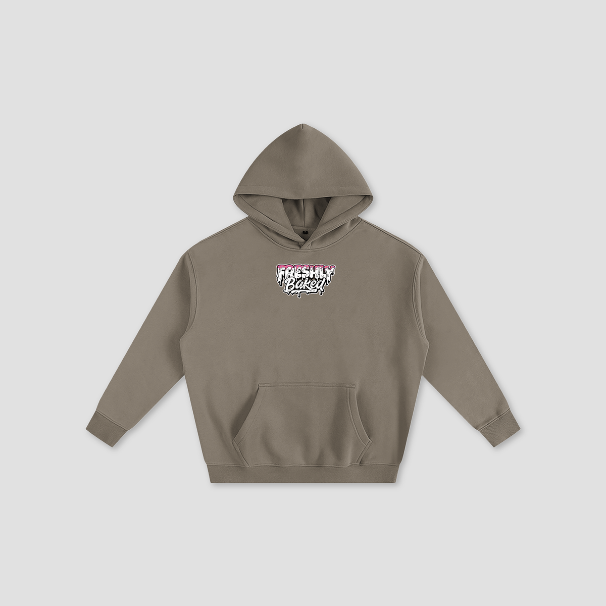 A taupe brown pullover hoodie with a front kangaroo pocket and a small graphic on the chest reading 'FRESHLY BAKED' in pink, white, and black, displayed on a light gray background.