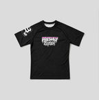 A black short-sleeve athletic t-shirt with a 'Freshly Baked' graphic in pink and white on the chest, and a white graphic on the right sleeve, displayed flat against a light gray background.