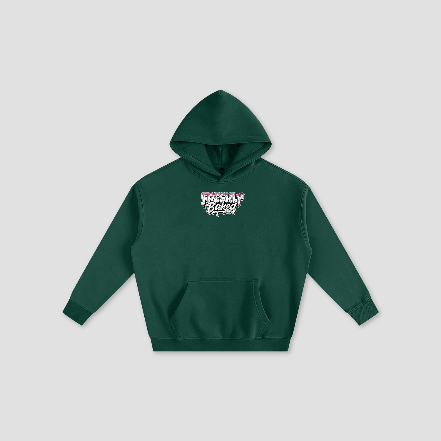 A dark green pullover hoodie with a small graphic on the chest reading 'Freshly Baked' in white, pink, and black, displayed on a light gray background.