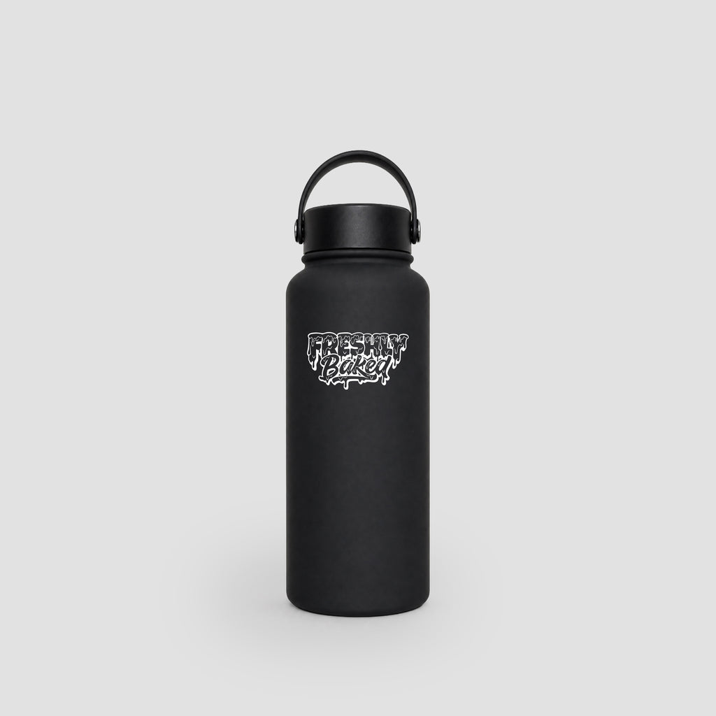 A matte black insulated water bottle with a carrying loop lid and a white 'Freshly Baked' logo on the front, set against a light gray background.