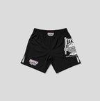 Black athletic shorts with white and pink graphics, featuring a large cartoon graphic on the right leg and a smaller graphic on the left leg, shown against a solid gray background.