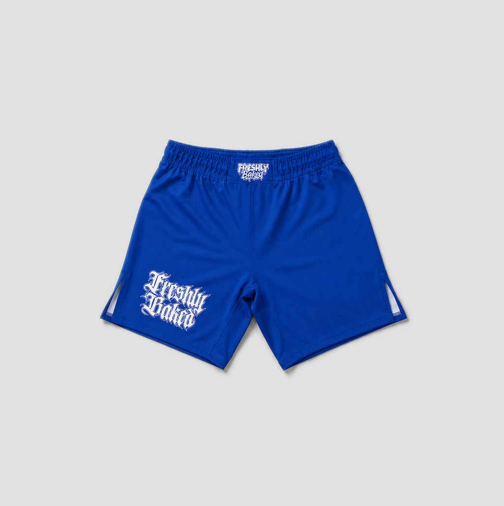 Royal blue athletic shorts with white 'Freshly Baked' text graphics on the left leg and a white logo on the waistband, shown against a light gray background.