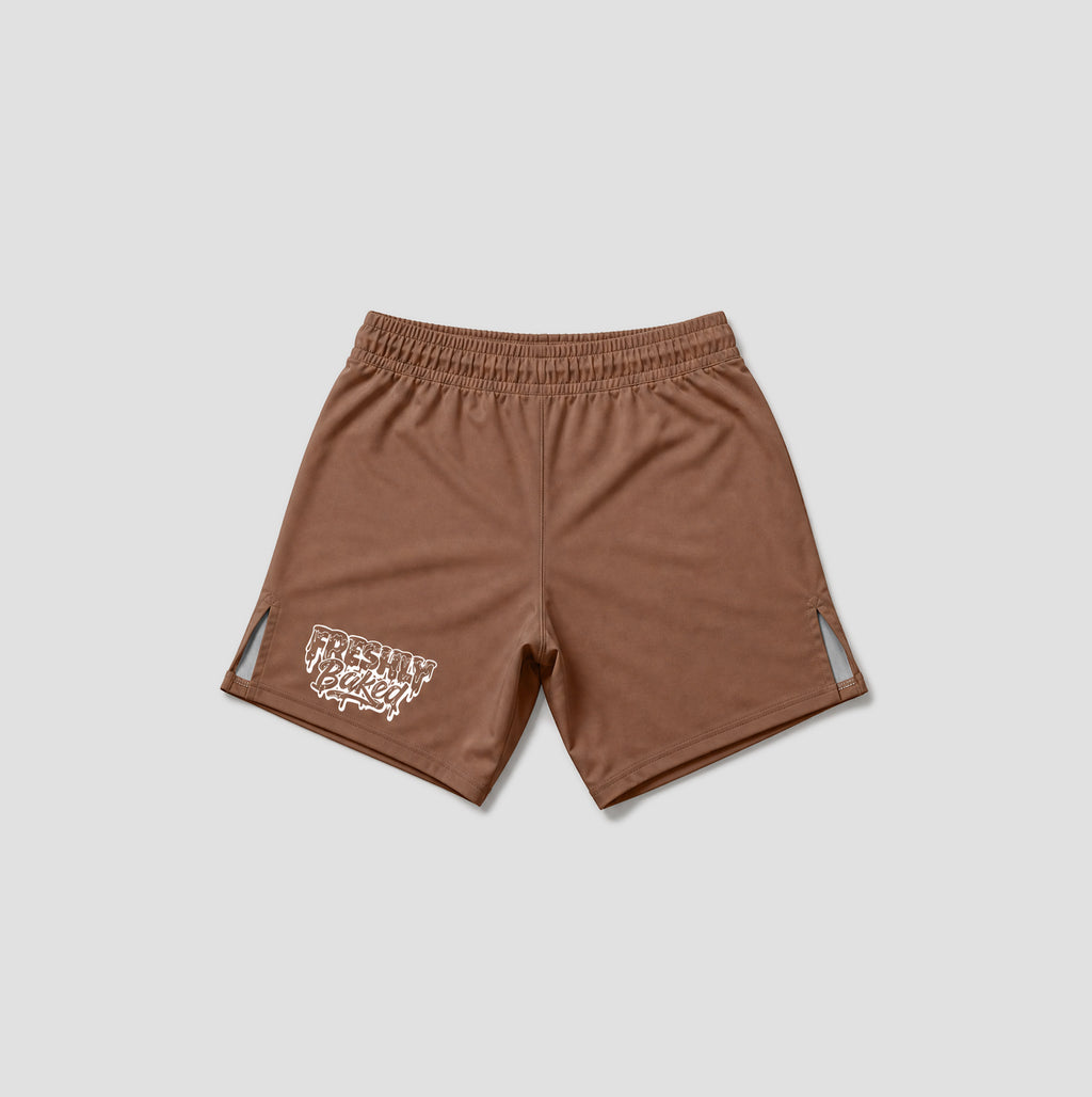 A pair of brown athletic shorts with an elastic waistband, featuring a white graphic print on the lower left leg and small side cutouts, displayed on a light gray background.