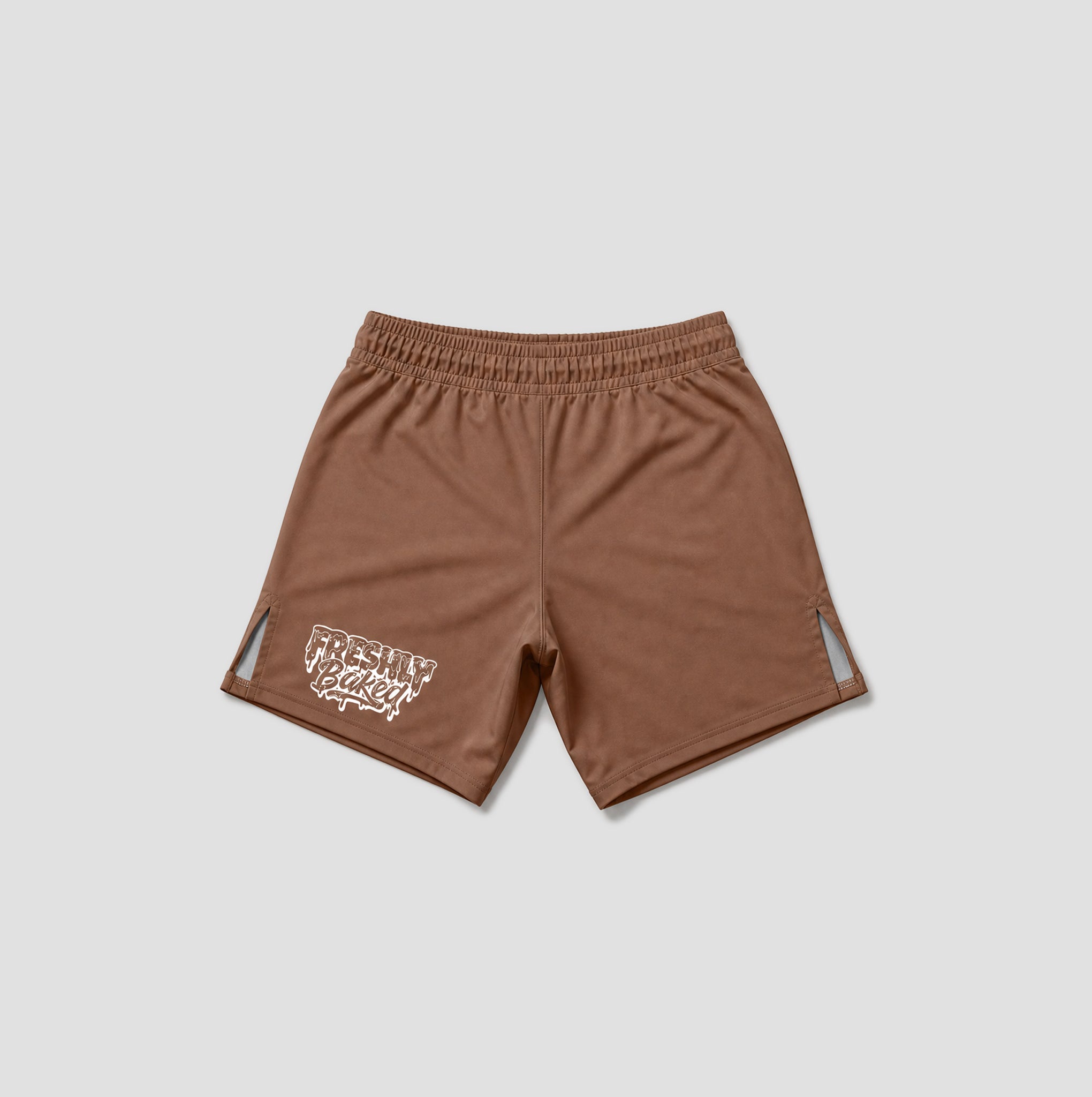 A pair of brown athletic shorts with an elastic waistband, featuring a white graphic print on the lower left leg and small side cutouts, displayed on a light gray background.