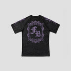 A black short-sleeve t-shirt with a distressed texture, featuring a large purple gothic-style monogram 'FB' inside an ornate frame on the back, with purple decorative details on the shoulders, shown against a light gray background.
