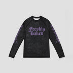 A long-sleeve black athletic shirt with a purple 'Freshly Baked' gothic text graphic on the chest and purple tribal-style sleeve prints, displayed flat against a light gray background.