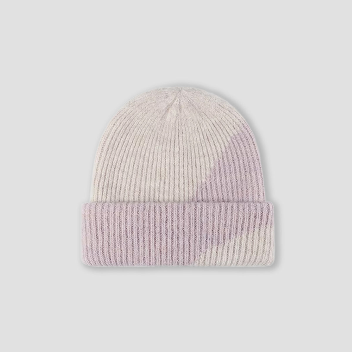 A ribbed knit beanie hat in a soft geometric color-block pattern of cream, light pink, and pale lavender, shown against a neutral light gray background.