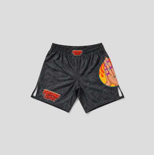 Black acid-wash athletic shorts with red and orange graphics, including 'FRESHLY BAKED' text and a hand illustration with flames, shown on a light gray background.