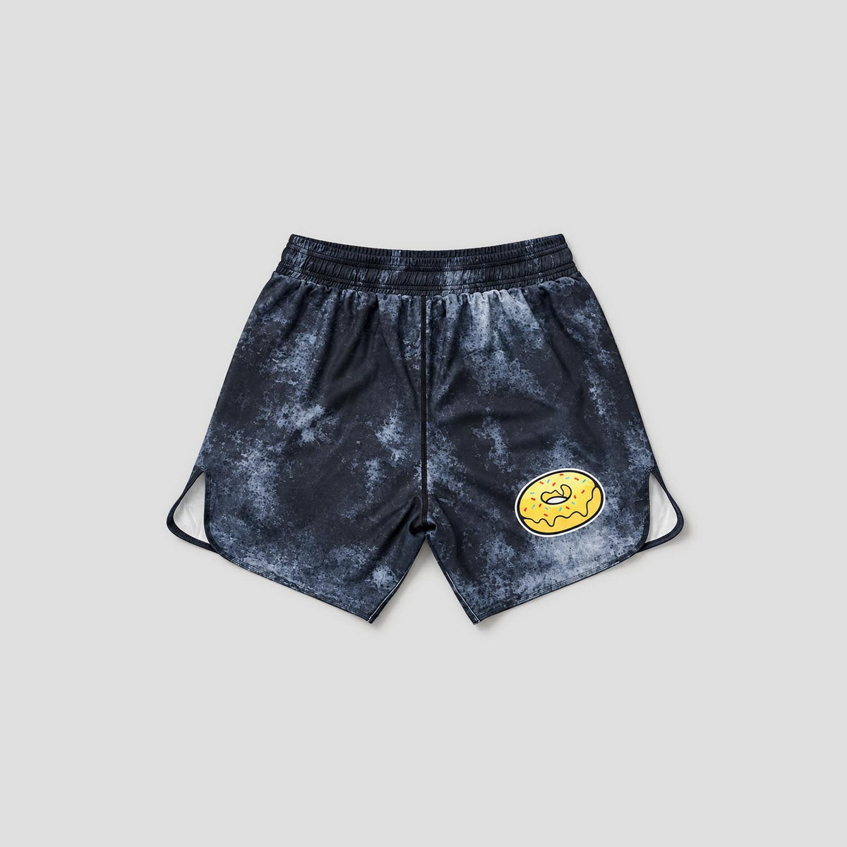 Dark navy blue athletic shorts with a mottled tie-dye pattern, featuring a yellow cartoon donut logo on the left leg and adjustable side drawstrings, shown against a light gray background.
