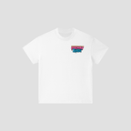 A white short-sleeve crewneck t-shirt with a colorful graphic on the left chest reading 'FRESHLY BAKED' in pink, blue, and black, displayed on a light gray background.