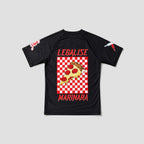A black short-sleeve t-shirt with a red and white checkered graphic on the front featuring a slice of pepperoni pizza and the text 'LEGALISE MARINARA' in red. The shirt also has small red and white graphics on both sleeves, shown against a light gray background.