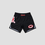 Black athletic shorts with red and white graphics, featuring a skull logo on the left leg and a circular patch on the right leg, displayed against a light gray background.