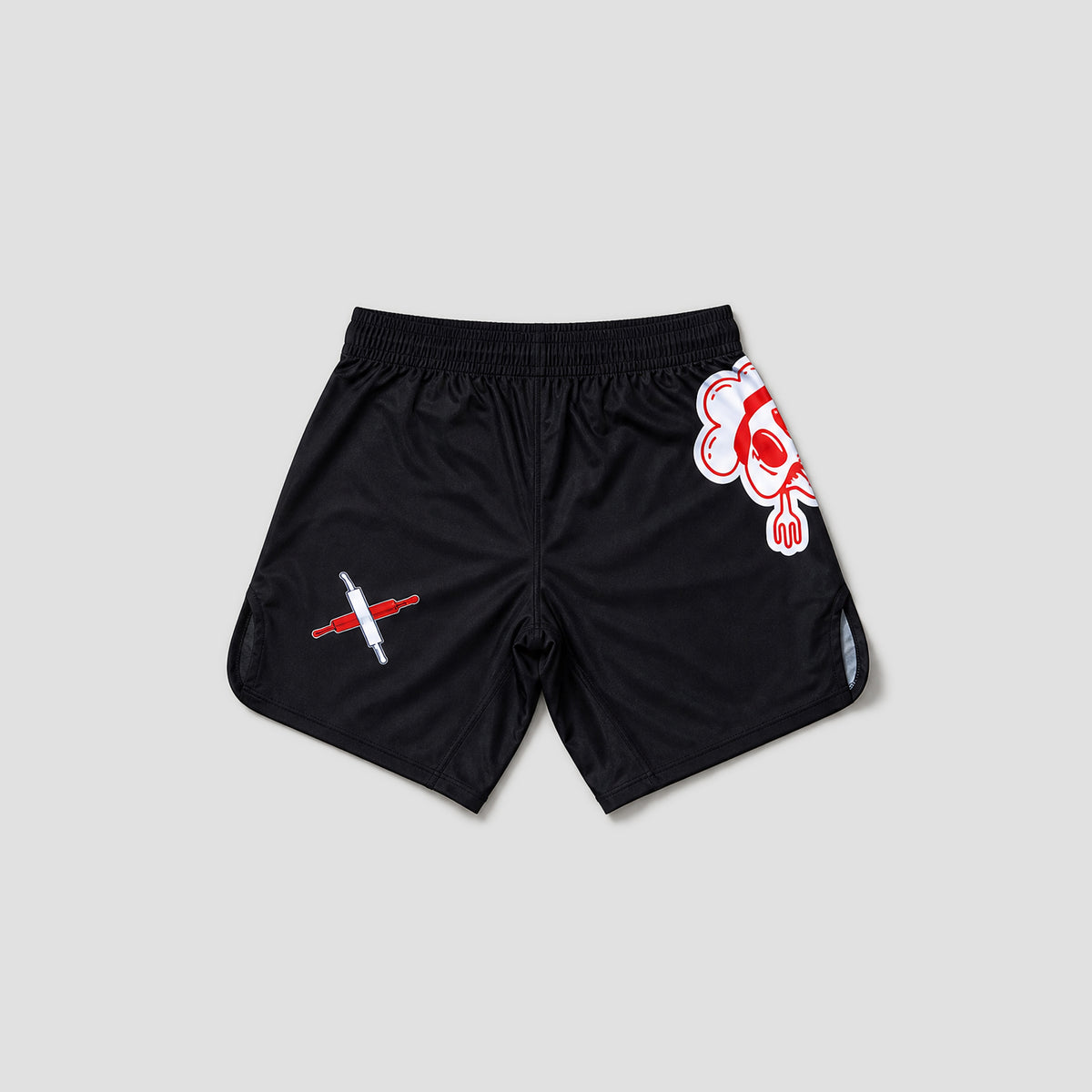 Black athletic shorts with a red and white graphic design on the left leg and a red and white cartoon face on the right leg, shown flat on a light gray background.