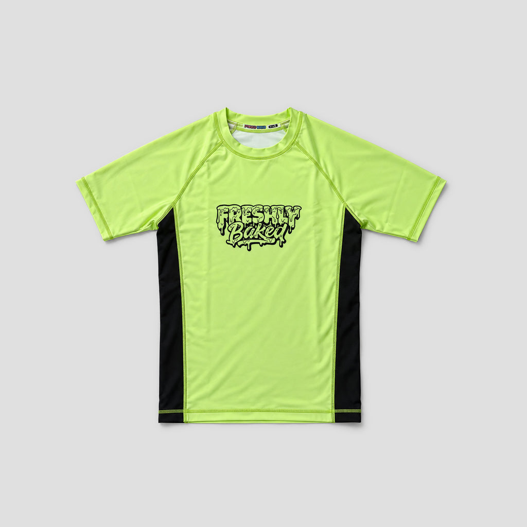 A neon yellow-green short-sleeve athletic t-shirt with black side panels and a black 'Freshly Baked' logo on the chest, displayed flat against a light gray background.
