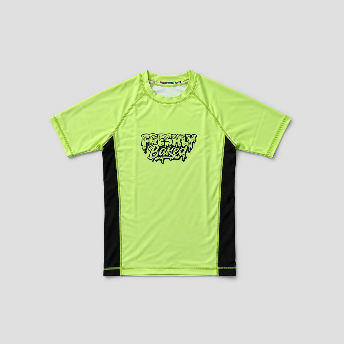 A neon yellow-green short-sleeve athletic t-shirt with black side panels and a black 'Freshly Baked' logo on the chest, displayed flat against a light gray background.