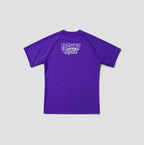 A purple short-sleeve athletic t-shirt with a white stylized graphic on the upper back, displayed flat against a light gray background.