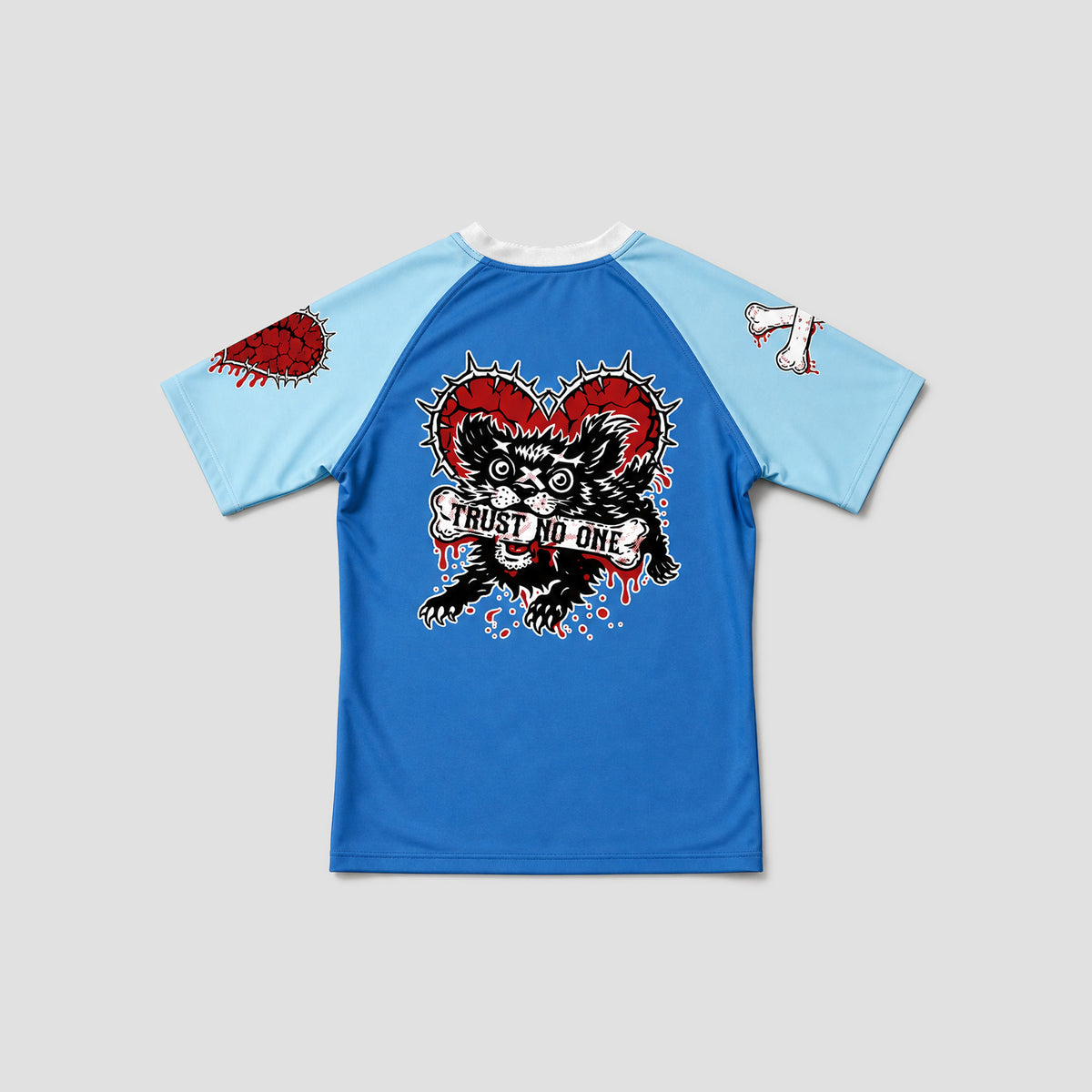 A blue and light blue raglan t-shirt featuring a large graphic on the front of a black cat holding a banner that reads 'TRUST NO ONE' in front of a red heart. The sleeves are light blue with a red heart graphic on the right sleeve and a white cross on the left sleeve.