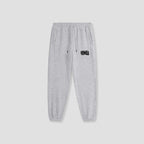 Light gray heather sweatpants with a black 'Freshly Baked' logo on the left thigh, featuring an elastic waistband with drawstrings and elastic cuffs, shown against a light gray background.