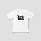 A white short-sleeve t-shirt with a black gothic-style 'Freshly Baked' graphic printed on the chest, displayed against a solid light gray background.