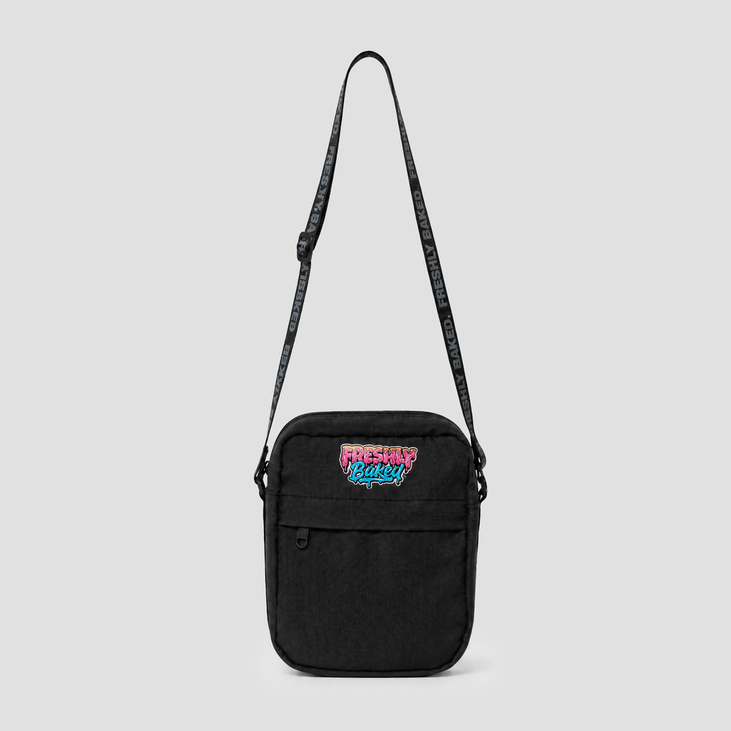 A black canvas crossbody bag with a colorful 'Gotta Go Back' graphic patch on the front pocket and a black patterned shoulder strap, shown against a light gray background.