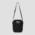 A black canvas crossbody bag with a colorful 'Gotta Go Back' graphic patch on the front pocket and a black patterned shoulder strap, shown against a light gray background.