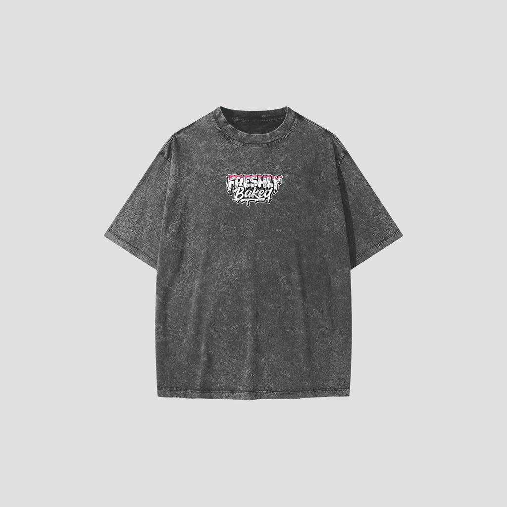 A dark gray acid-wash t-shirt with a 'Freshly Baked' graphic on the chest, displayed against a solid light gray background.
