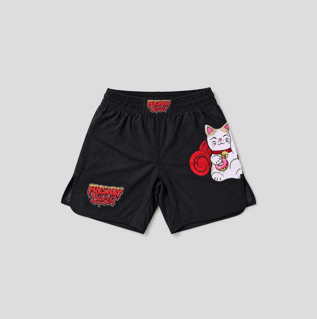 Black athletic shorts featuring a white and red cartoon Maneki-neko (lucky cat) graphic on the right leg and red and yellow 'Freshman 2024' text graphics on the left leg, displayed flat on a light gray background.