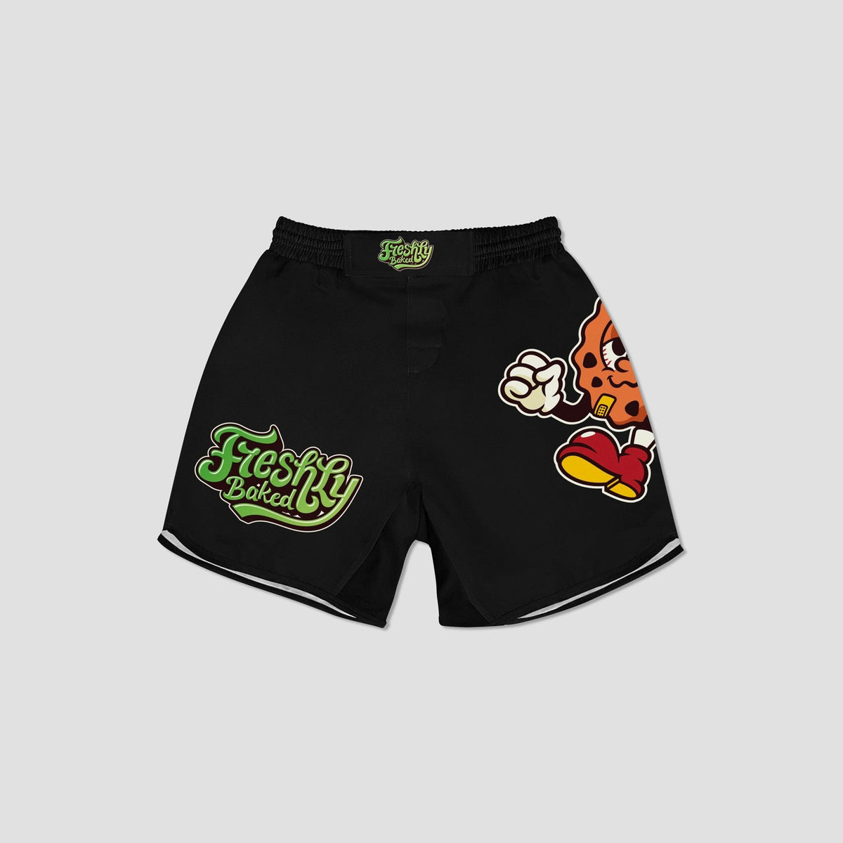 Black athletic shorts featuring a green 'Freshly Baked' logo on the left leg, a cartoon chili pepper graphic on the right leg, and white piping along the hem, shown against a light gray background.